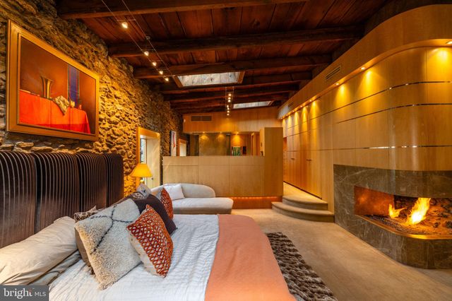 a bedroom with a bed next to a window with the outer view