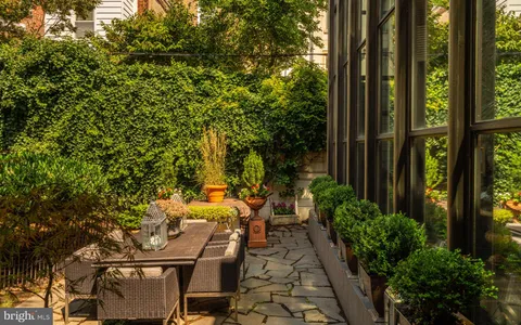 a view of a house with a backyard and a tree