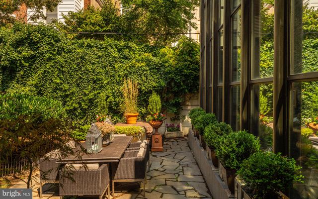 a view of a house with a backyard and a tree