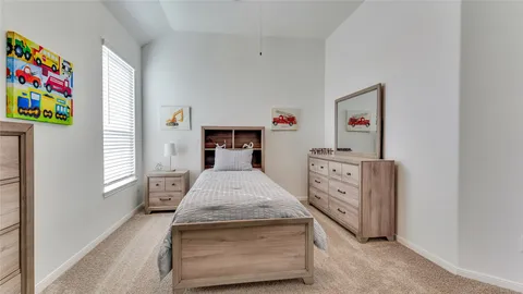a bedroom with a bed and a dresser