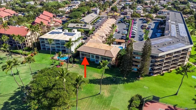 an aerial view of residential houses with outdoor space and trees