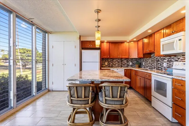 a kitchen with stainless steel appliances granite countertop a stove a sink dishwasher and cabinets