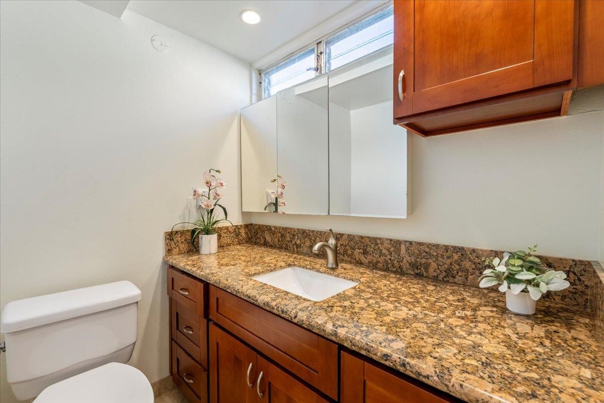 1002 South Kihei Road, Unit 212 Kihei, HI 96753 - Photo 20 of 50 a bathroom with a granite countertop sink and a mirror