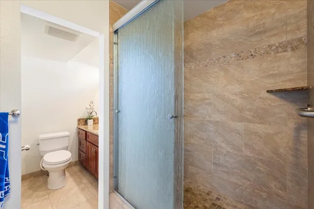 a white toilet sitting next to a shower