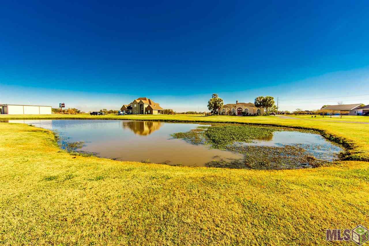 611 Highway 653 Raceland, LA 70394 - Photo 2 of 19 Stocked pond in front of home