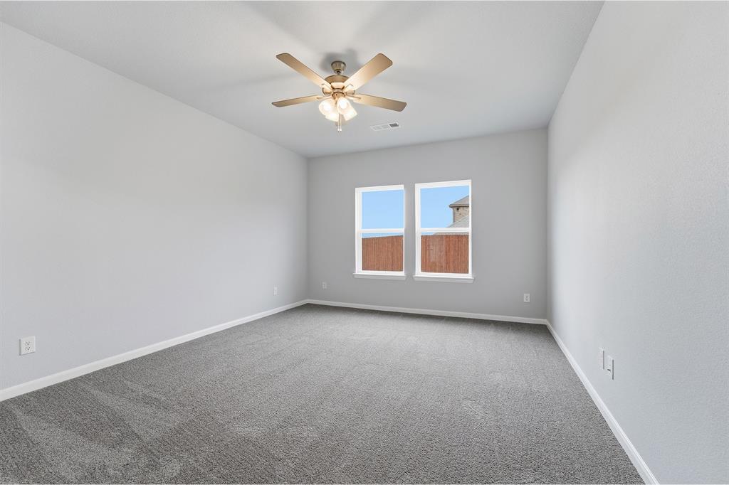 343 Caviar Road Waxahachie, TX 75165 - Photo 16 of 22 an empty room with windows and fan