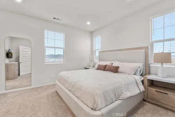 a bedroom with a large bed and a window