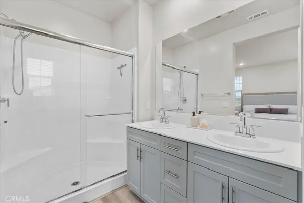 a bathroom with a shower sink and mirror
