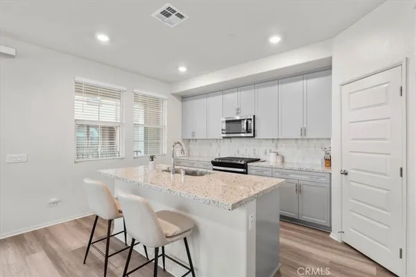 a kitchen with appliances cabinets and a counter top space