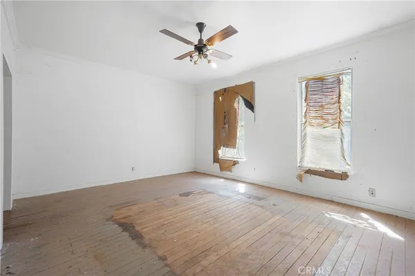 a view of a room with a fireplace cabinet and windows
