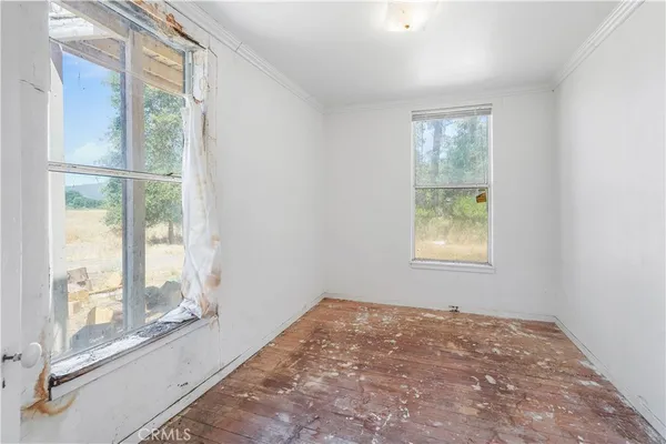 an empty room with windows and closet