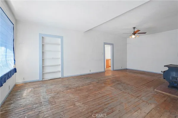 a view of a kitchen with furniture and a ceiling fan