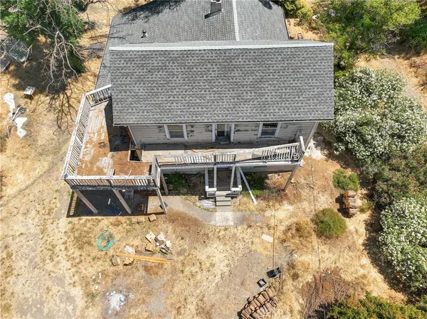 an aerial view of a house with a yard