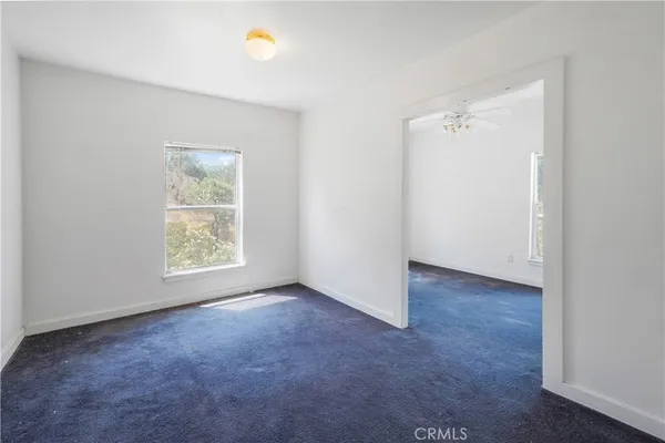 an empty room with a ceiling fan
