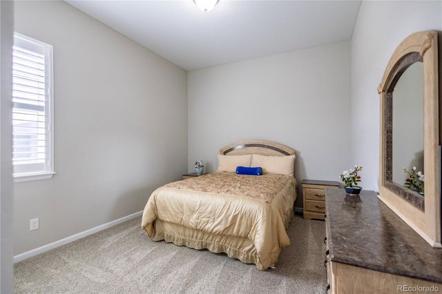 a bedroom with a bed and a mirror