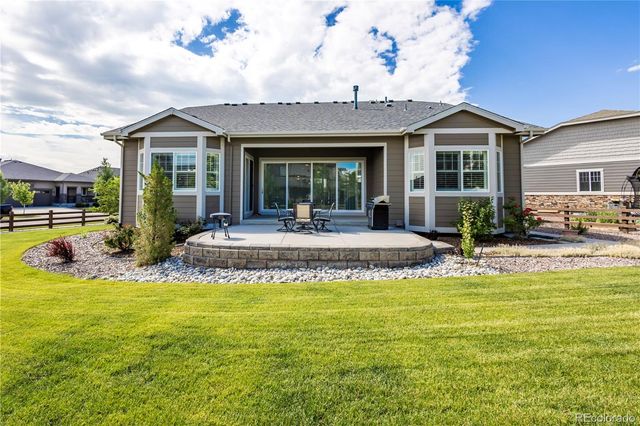 a view of a house with swimming pool and porch with furniture