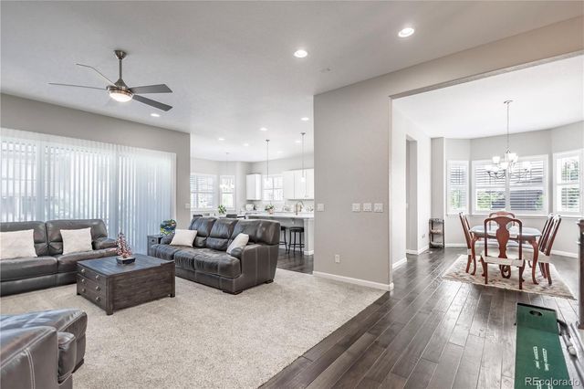 a living room with furniture wooden floor and a window