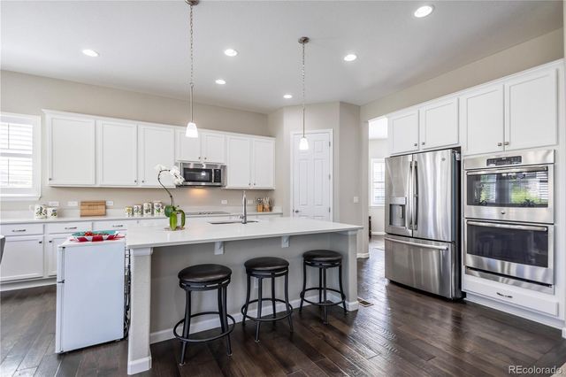 a kitchen with stainless steel appliances granite countertop a refrigerator sink and cabinets