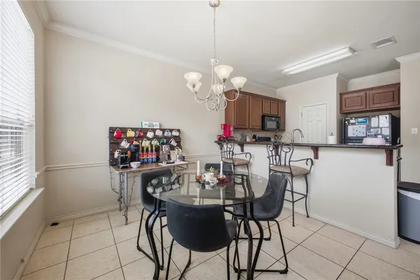 a view of a dining room with furniture and a chandelier