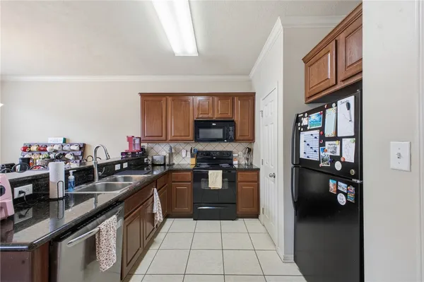 a kitchen with a refrigerator and a sink