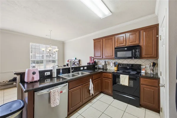 a kitchen with stainless steel appliances granite countertop a sink stove and cabinets