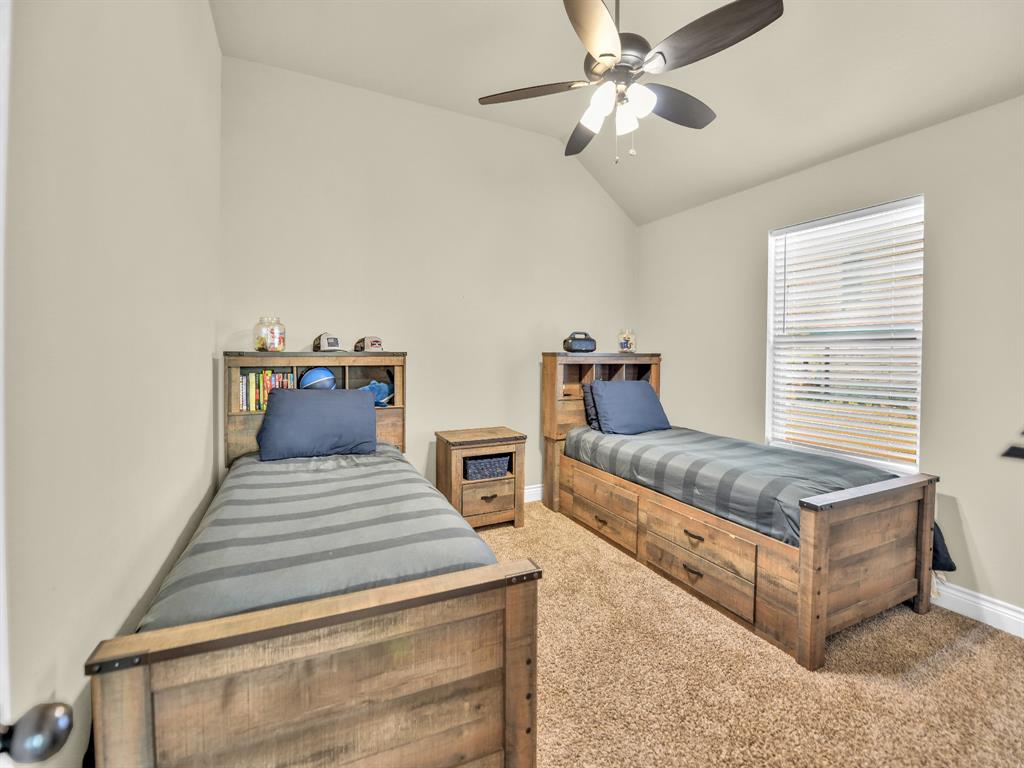 156 Cottongame Road Weatherford, TX 76088 - Photo 24 of 35 a bedroom with furniture and a chandelier