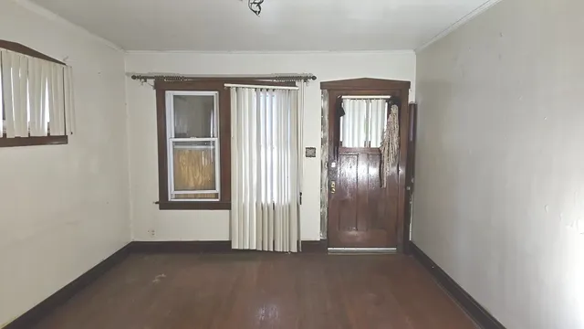 an empty room with windows and entrance