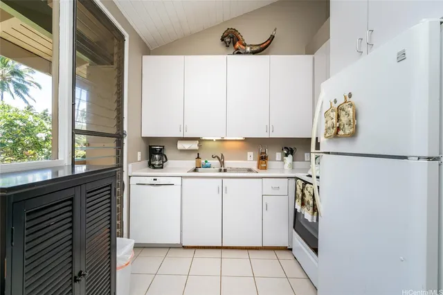 a kitchen with a white cabinets and a stove top oven