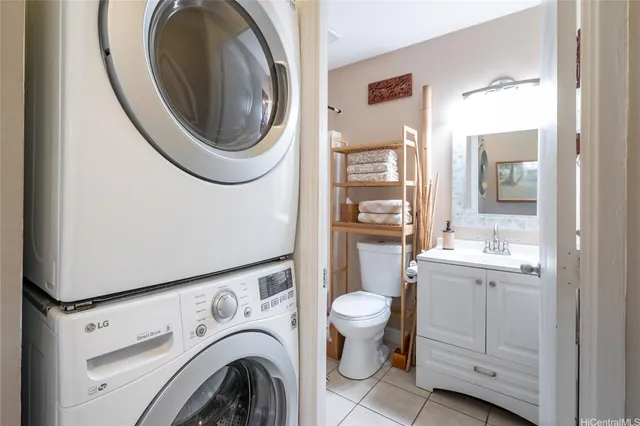 a view of a bathroom with washing machine and sink