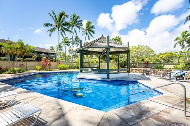a view of a swimming pool with a lounge chairs