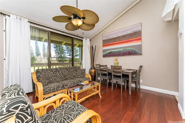 a dining room with furniture a large window and a chandelier