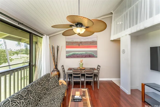 a dining room with wooden floor and a chandelier