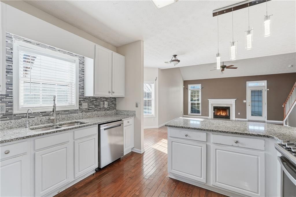 1402 Edgeley Way Lawrenceville, GA 30044 - Photo 11 of 23 a kitchen with granite countertop stainless steel appliances sink and cabinets