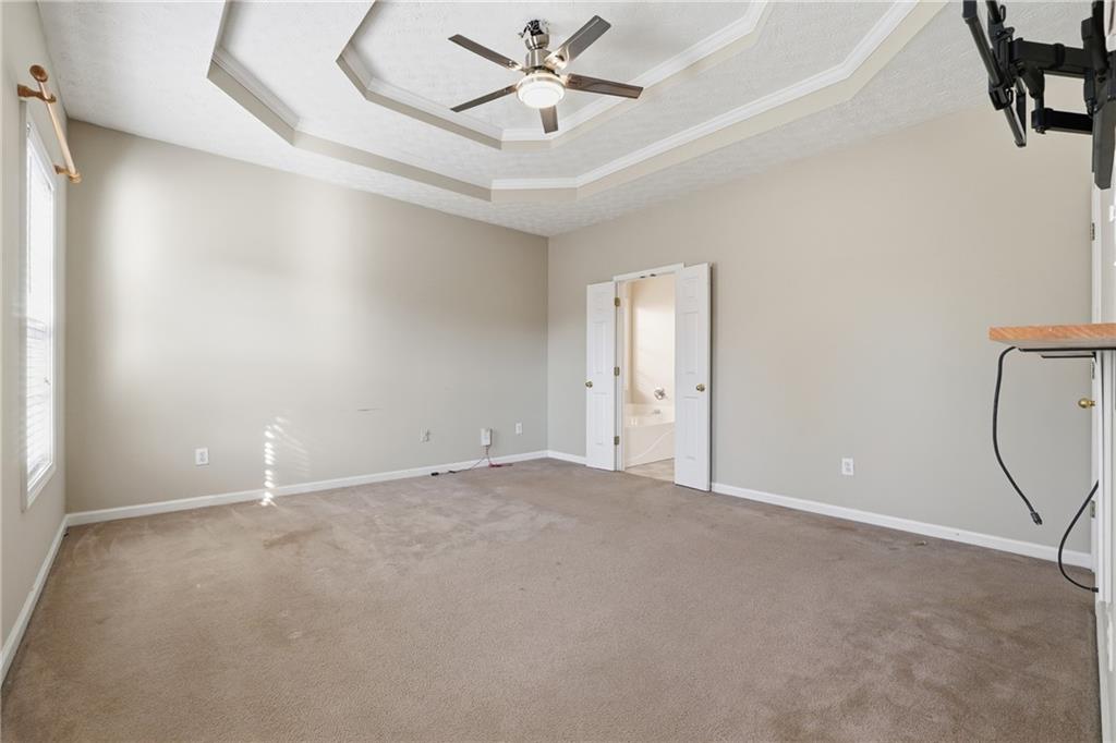 1402 Edgeley Way Lawrenceville, GA 30044 - Photo 14 of 23 an empty room with windows and fan