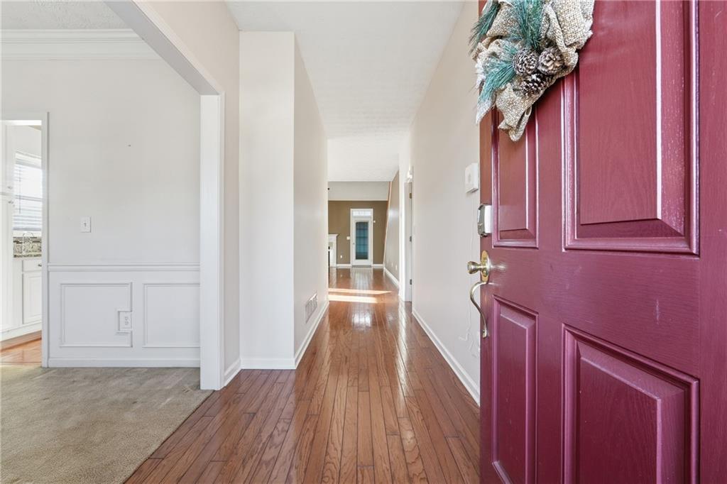 1402 Edgeley Way Lawrenceville, GA 30044 - Photo 2 of 23 a view of a hallway with wooden floor and staircase