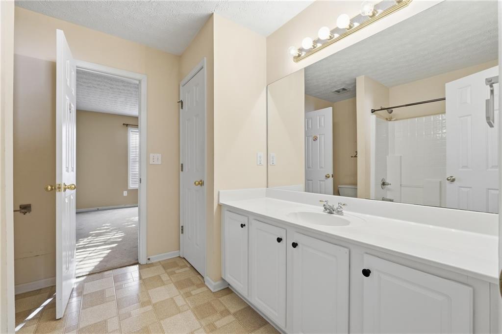 1402 Edgeley Way Lawrenceville, GA 30044 - Photo 21 of 23 a bathroom with a sink and a mirror