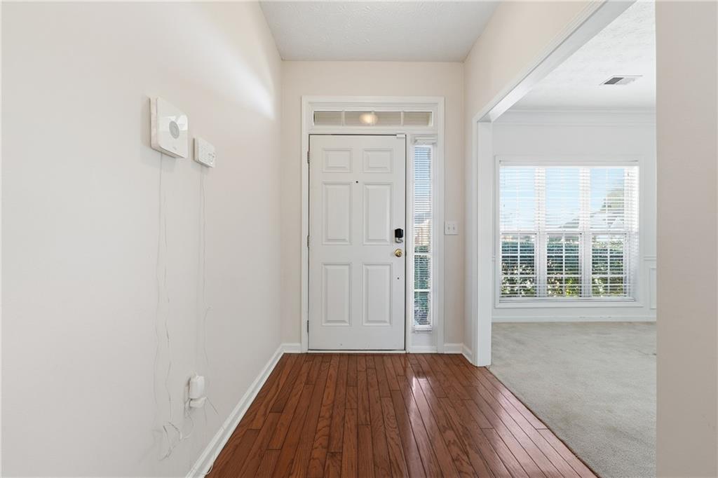 1402 Edgeley Way Lawrenceville, GA 30044 - Photo 3 of 23 an empty room with wooden floor and windows