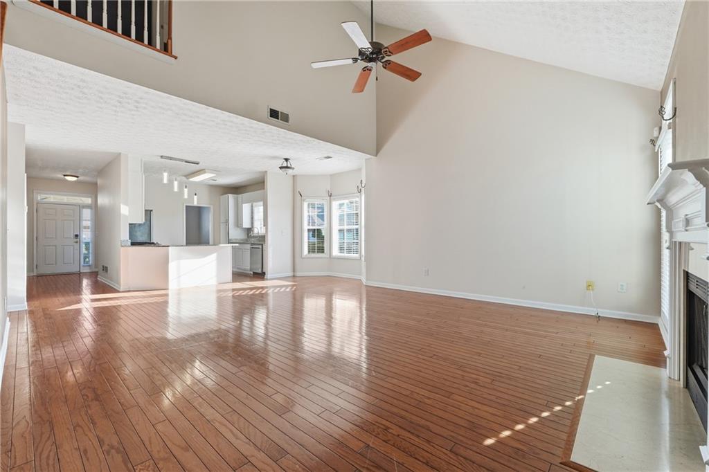 1402 Edgeley Way Lawrenceville, GA 30044 - Photo 8 of 23 a view of a room with wooden floor and a ceiling fan