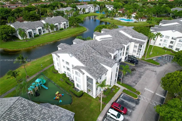 an aerial view of a house with outdoor space pool patio and lake view