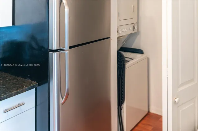 a kitchen with a refrigerator and cabinets