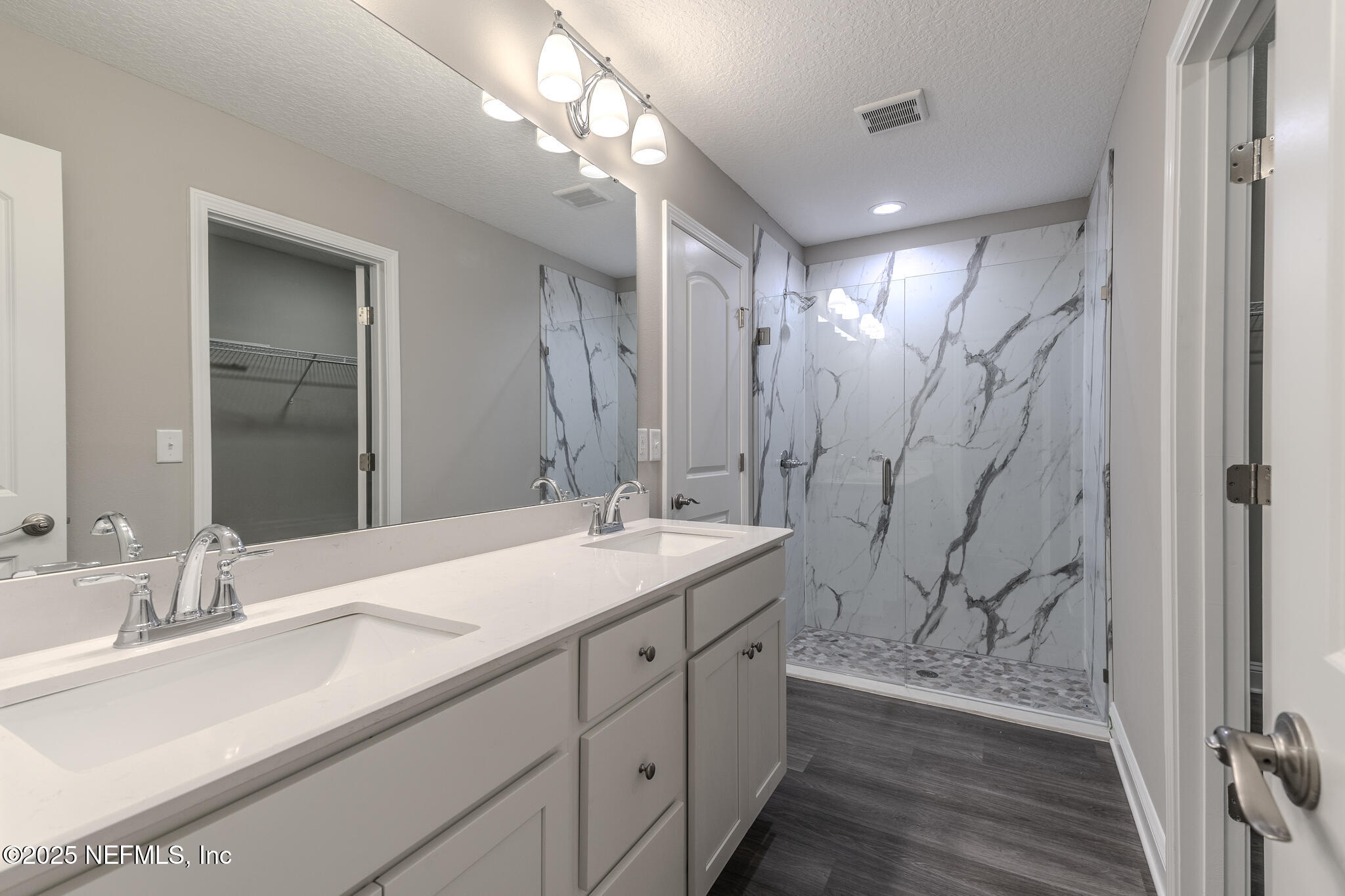 451624 Old Dixie Highway Callahan, FL 32011 - Photo 11 of 20 a spacious bathroom with a double vanity sink a mirror and a shower