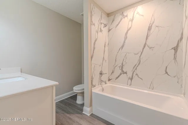 a bathroom with a bathtub and shower