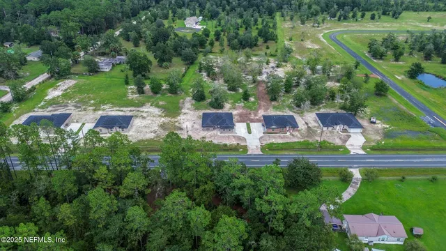 an aerial view of a house with outdoor space and street view