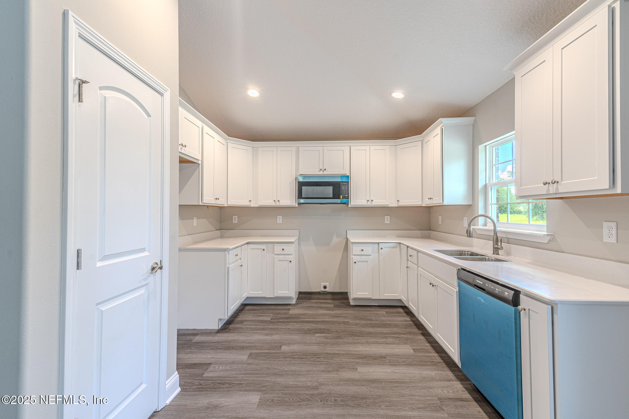 451624 Old Dixie Highway Callahan, FL 32011 - Photo 8 of 20 a kitchen with granite countertop white cabinets and white appliances