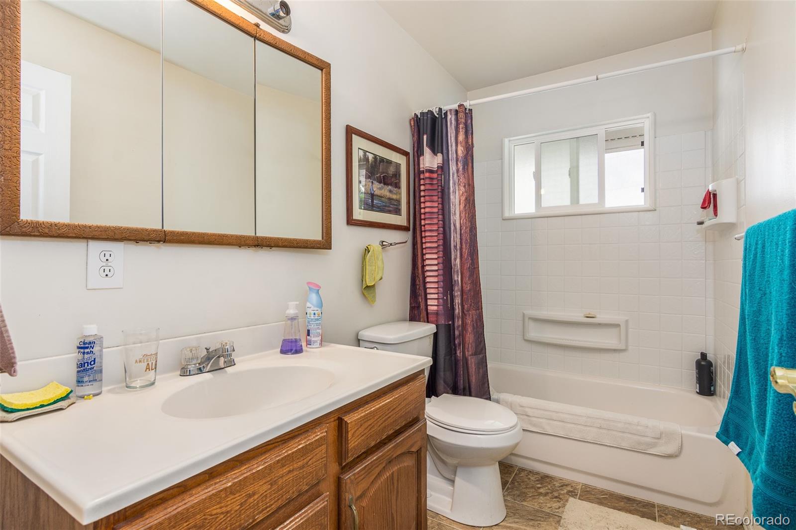 4865 Garrison Street Wheat Ridge, CO 80033 - Photo 11 of 40 a bathroom with a sink a toilet and shower