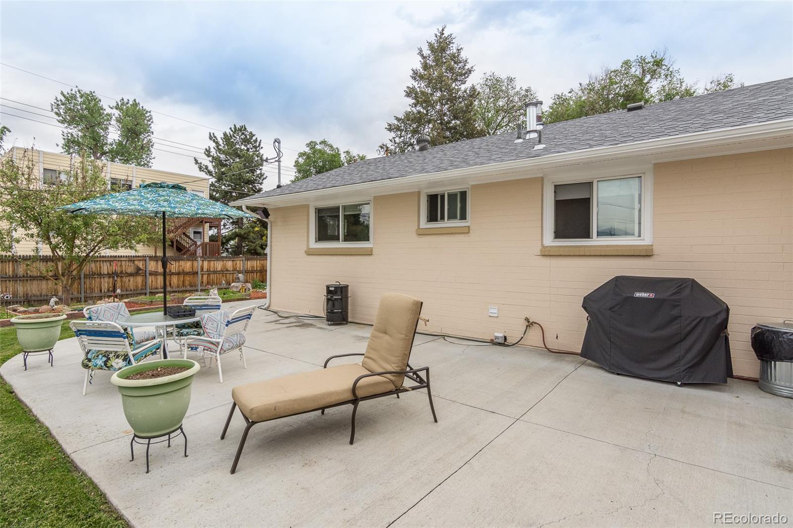 4865 Garrison Street Wheat Ridge, CO 80033 - Photo 34 of 40 a view of a patio with table and chairs and potted plants