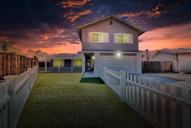 a view of a house with a yard