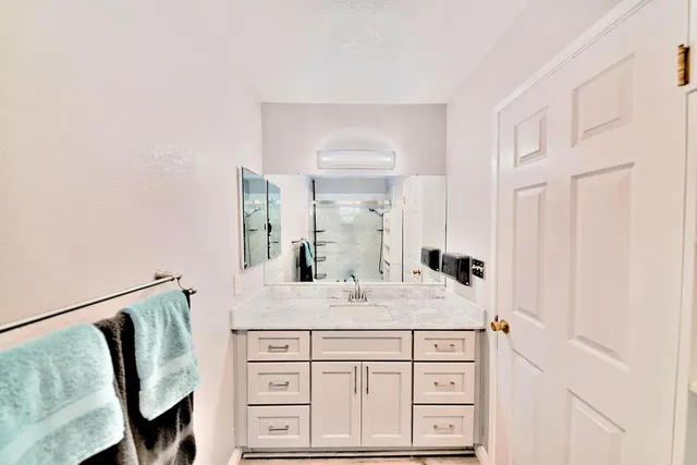 a bathroom with a sink and a mirror