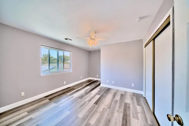 a view of room with window and wooden floor