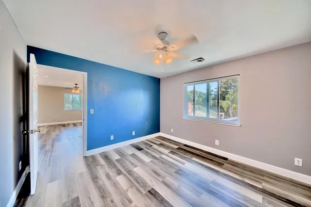 wooden floor in an empty room with a window